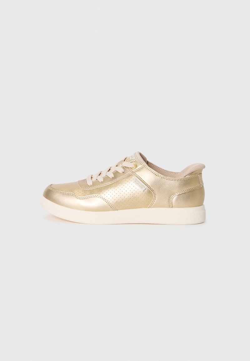 Low-top metallic gold sneaker with beige laces, perforated side panel, and white cushioned sole on plain background.