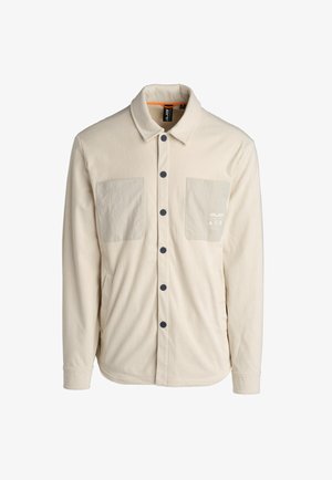 Beige corduroy shirt met een verhoogde textuur, twee opgestikte zakken, zwarte knopen en een oranje accent aan de binnenkant van de kraag.