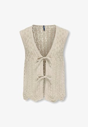 Gilet sans manches tricoté couleur crème avec devant ouvert noué par deux nœuds papillon, présentant un motif en dentelle et un ourlet festonné.