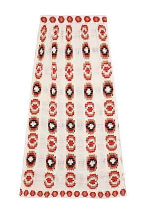 Flerfarvet vævet tæppe med et gentaget mønster af røde, sorte og hvide ovale former på en cremet baggrund. Tekstureret overflade.