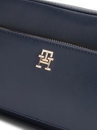 Navy leather wallet featuring a gold-tone logo and zip closure. Sleek design with smooth texture and minimalistic stitching details.