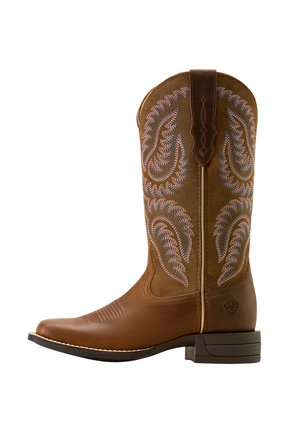 Brown leather cowboy boot with decorative stitching in blue and pink paisley pattern. Features a pointed toe and stacked heel.