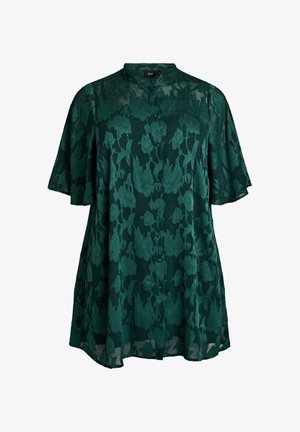 Smaragdinvihreä kukkainen pitsipaita lyhyillä hihoilla, napitus edessä ja rento istuvuus. Läpinäkyvä kangas kohotetuilla kukkakuviolla.