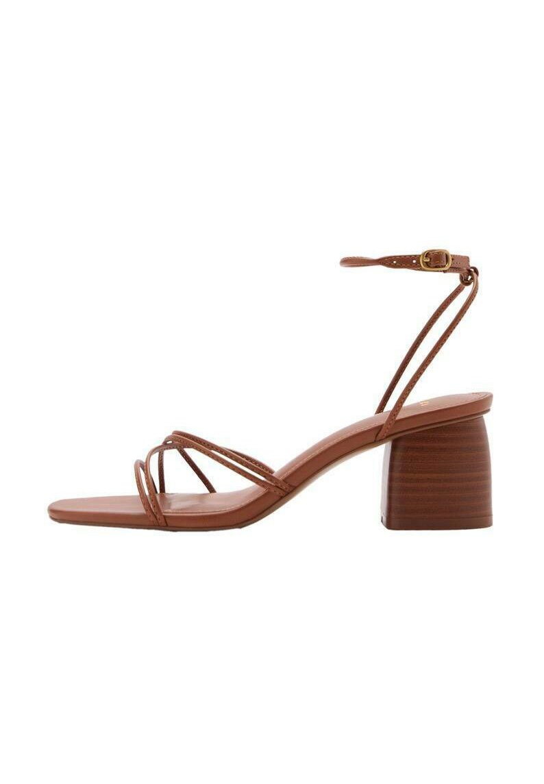 Brown strappy heeled sandal with a block heel. Adjustable ankle strap, square toe, smooth texture, and minimalistic design.
