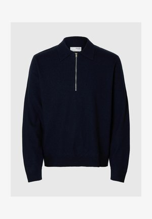 Pull bleu marine avec col et fermeture éclair quart, en matériau doux. Dispose de manches longues et d'un design ajusté à la taille.