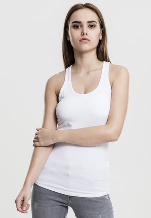 Weißes Tanktop mit Rundhalsausschnitt, taillierter Passform und ohne Verzierungen, kombiniert mit hellgrauen Jeans. Schlichte und nahtlose Erscheinung.