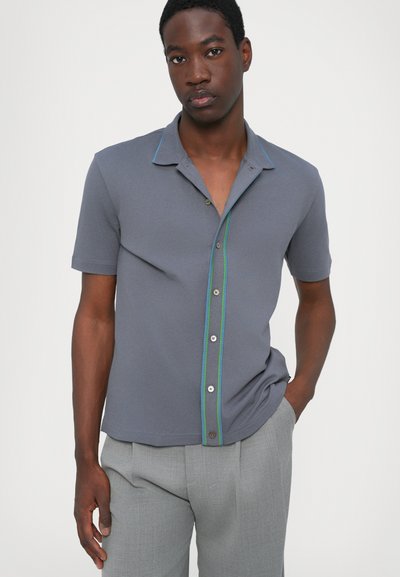 Grey short-sleeve polo shirt with a contrasting green button placket and collar, featuring a smooth texture and classic fit.