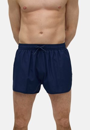 Bañadores azul marino hechos de material ligero, con una cintura elástica y cordón ajustable, y un diseño de ajuste relajado.