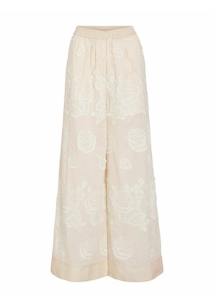 Pantalon large crème avec taille élastique, orné d’un motif floral texturé sur l’ensemble du tissu.