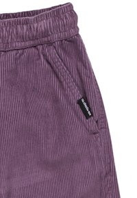 Violetti kangaskankaiset housut joustavalla vyötäröllä, sivutaskuilla ja pieni musta logotagi vasemmalla. Valmistettu textured ribbed -pinnasta.