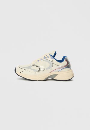 Ivory sneakers with mesh and leather materials, rounded toe, blue accents on collar, gray midsole, and red logo on the side. Textured details present.