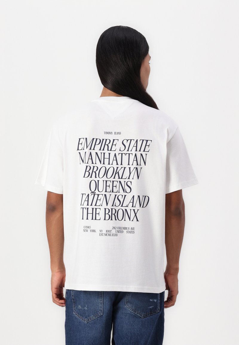 White cotton t-shirt featuring black text listing locations in New York City. Loose fit with short sleeves and a crew neck.