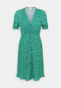 Grünes Blumenkleid mit kurzen Ärmeln, V-Ausschnitt und durchgehendem Knopfverschluss. Besitzt kleine rosa und weiße Blumen auf einem strukturierten Stoff.