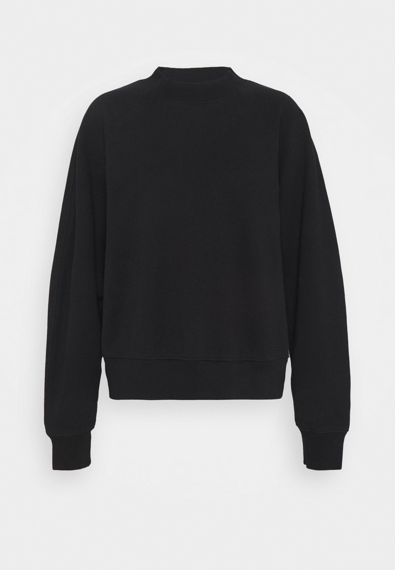 Sudadera negra con cuello redondo, mangas raglán y puños acanalados; fabricada en un material suave y liso con un corte holgado.