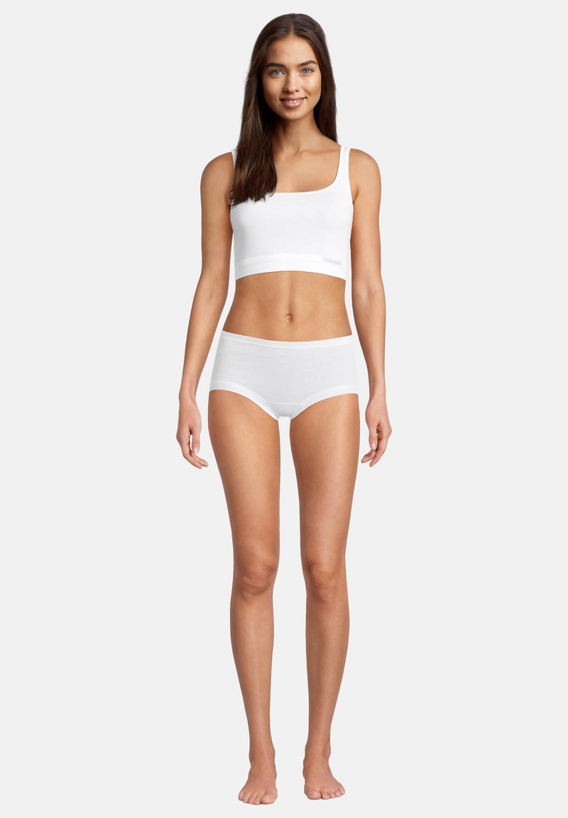 Brassière bianca in cotone con spalline sottili e un ampia fascia sottoseno, abbinata a slip hipster bianchi coordinati con un design morbido e senza cuciture.