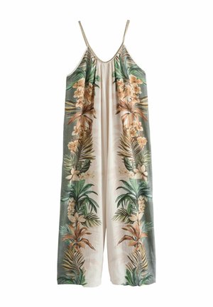 Sleeveless long jumpsuit with thin braided straps, featuring green and brown tropical floral patterns on cream fabric.