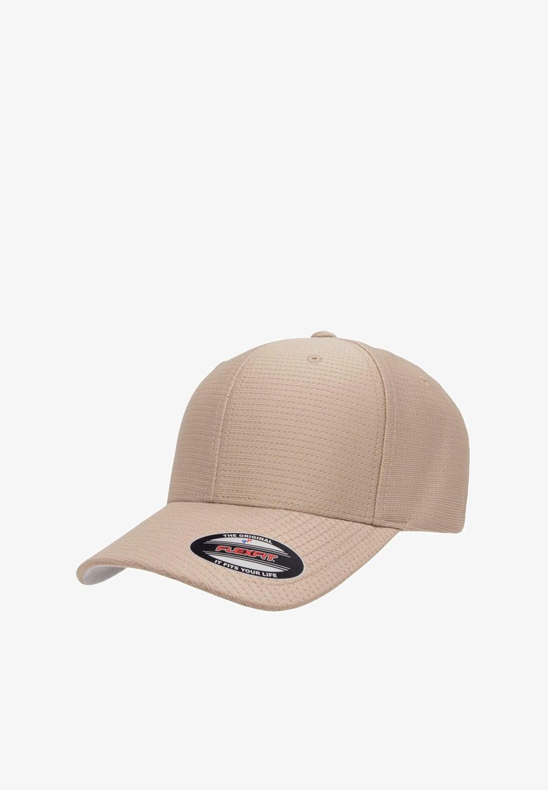 Beige baseball cap made of textured fabric, featuring a curved brim and a round crown, with a black and red logo tag on the front.