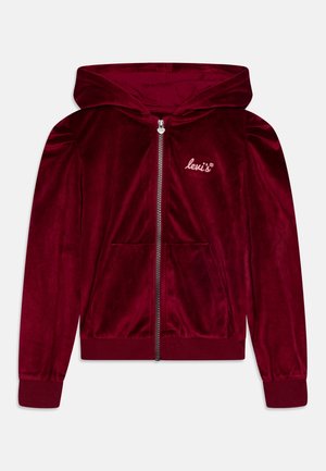 Sweat à capuche zippé en velours bordeaux avec une poche avant, des poignets et un ourlet côtelés. Présente un petit logo brodé sur la poitrine gauche.