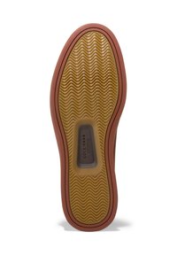 Rubberen schoenzool met een golvend profiel, in een tan kleur, met bruine accent en een grijze logo-insert. Getextureerde grip voor traction.