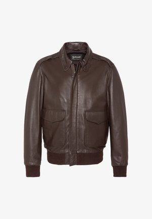 Brązowa skórzana kurtka bomber z przednim zamkiem błyskawicznym, dwoma kieszeniami z klapkami, prążkowanymi mankietami i pasem, z klasycznym kołnierzem i metką marki Schott wewnątrz.