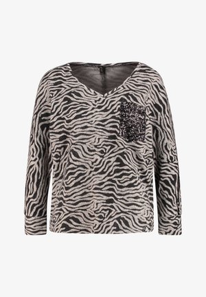 Czarny i szary top w paski zebry z długimi rękawami, dekoltem w serek i detalem z cekinowej kieszonki po lewej stronie. Miękka tkanina o luźnym kroju.