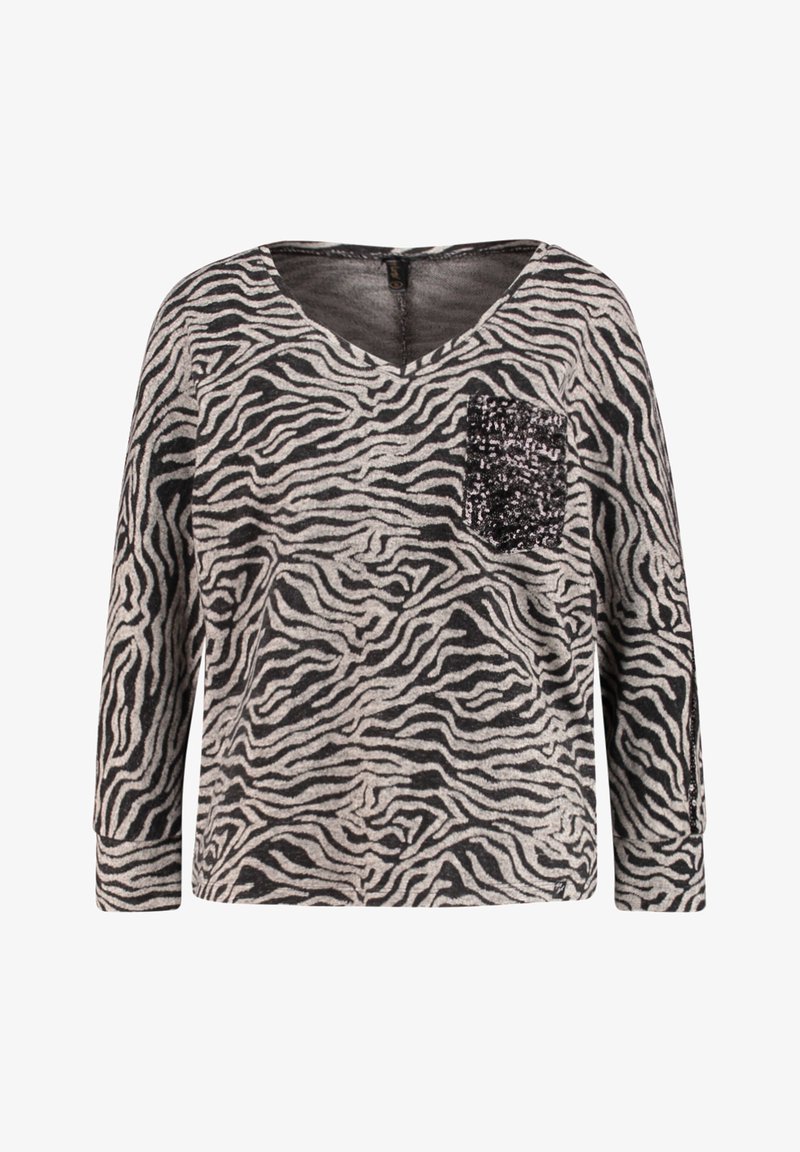 Czarny i szary top w paski zebry z długimi rękawami, dekoltem w serek i detalem z cekinowej kieszonki po lewej stronie. Miękka tkanina o luźnym kroju.