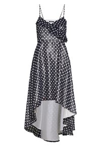 Svart och vit prickig ärmlös klänning med volangkrage och asymmetrisk hög-låg fåll.
