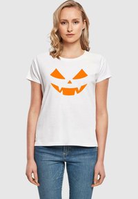 Witte katoenen t-shirt met een oranje pompoengezicht graphic. Korte mouwen, ronde hals en een relaxed fit. Geschikt voor casual dragen.