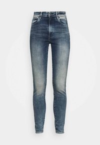 Jean skinny en denim bleu avec une finition délavée. Dotés d'une taille haute, d'une conception à cinq poches et de coutures contrastantes.