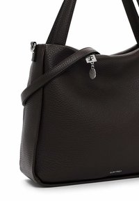 Brown textured leather handbag with two shoulder straps, silver hardware, and a metal tag. Features a rounded shape and a zip closure.