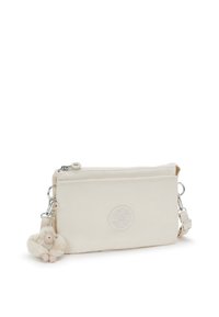 Borse a tracolla beige realizzata in morbido materiale, con chiusura a zip, emblema del logo e un charm di scimmia in pelliccia come dettaglio.