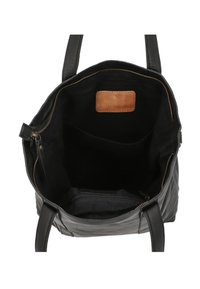 Schwarze Leder-Shopper-Tasche mit Reißverschluss, glatter Oberfläche, Innentasche und braunem Wildlederakzent. Breite Griffe für ein einfaches Tragen.