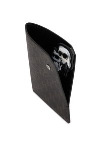 Black textured cardholder with a distinctive diagonal cut, featuring a silver snap closure and an interior cartoon character design.