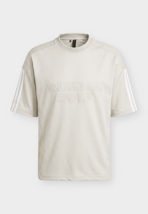 Maglietta Adidas Golf beige chiaro a maniche corte con scollo rotondo e tre strisce bianche sulle maniche.