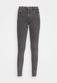 Grå denim skinny jeans med midjehöjd, fem fickor och knäppning. Slät textur med lätt blekning vid knäna.