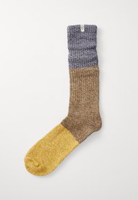 Knit sock with a folded cuff, featuring a gradient design in blue, brown, and yellow. Texture is soft and slightly chunky.