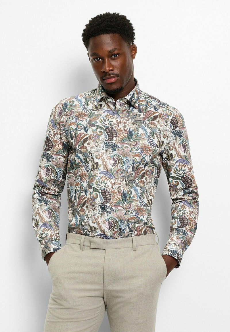 Long-sleeve button-up shirt featuring a colorful, intricate floral and paisley pattern on a light background; smooth fabric.