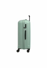 Valise rigide de couleur vert menthe mat, au design épuré, avec deux roues noires, une poignée rétractable et une serrure à combinaison intégrée.