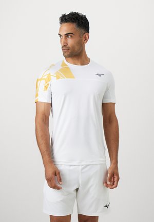 White athletic shirt with short sleeves and yellow geometric pattern on the shoulder. Features a black logo on the chest.