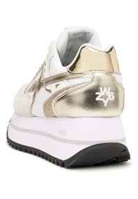 Vit och guldig sneaker med en texturerad ovandel, metalliska detaljer, en vadderad krage och en tjock vit sula med en svart mönstrad yttersula.