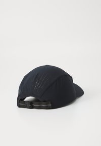 Black cap with a curved visor, made of lightweight fabric. Features perforated sections for ventilation and an adjustable strap at the back.