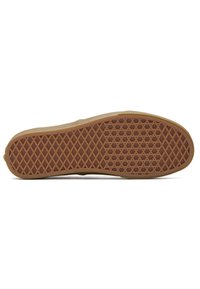 Suola di una scarpa in gomma con una texture a motivi che presenta un design a griglia a diamante, principalmente in tonalità beige con una base marrone per una migliore aderenza.