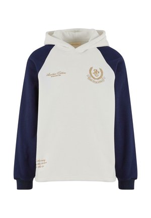 Balta kapuce džemperis ar tumši zilo raglan piedurknēm. Iekļauj zelta tekstu un emblēmu detaļas. Mīksts kokvilnas materiāls, brīvs piegriezums.
