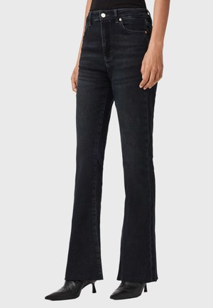 Höga svarta jeans med utsvängd bendesign, tillverkade av denim med en slät textur, minimal syddning och en framficka.