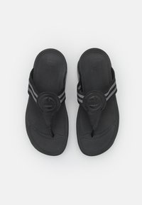 Black flip-flops featuring rubber soles, a textured footbed, and a prominent circular logo with two grey striped accents on the straps.