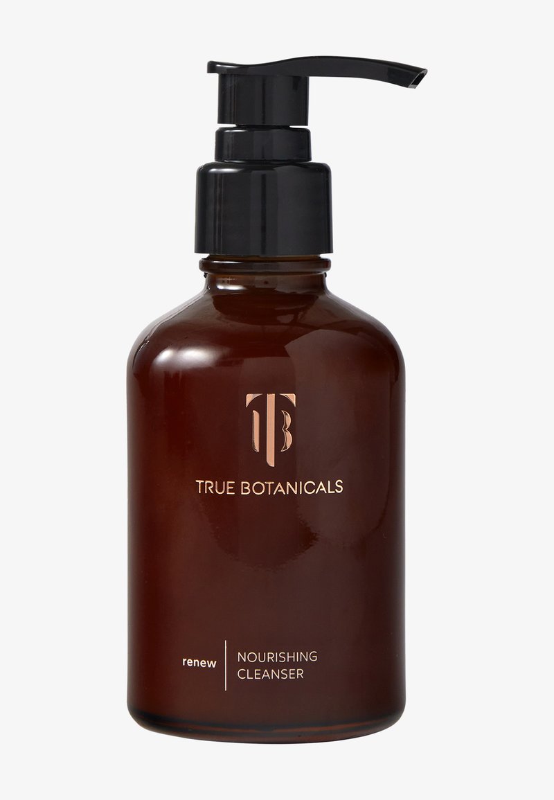 Bouteille en verre ambre avec une pompe noire ; l'étiquette présente "TRUE BOTANICALS" en doré ; le texte indique "renew" et "NETTOYANT NOURRISSANT."