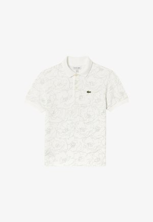 Polo blanco de manga corta con bordado floral sutil, tres botones y un pequeño logo de cocodrilo verde en el pecho izquierdo.
