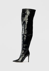 Bottines noires à talons hauts, au-dessus du genou, en cuir verni brillant, dotées d'un bout pointu et d'une texture lisse et élégante.