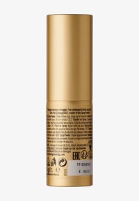 Contenitore cilindrico dorato con superficie lucida, etichettato per un prodotto in polvere spray. Contiene istruzioni in più lingue e icone di sicurezza.