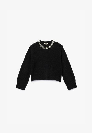 Mustat lyhyet hihat ja pyöreä pääntie, jossa on koristeellinen jalokivikoriste kauluksessa. Pehmeä tekstuuri.